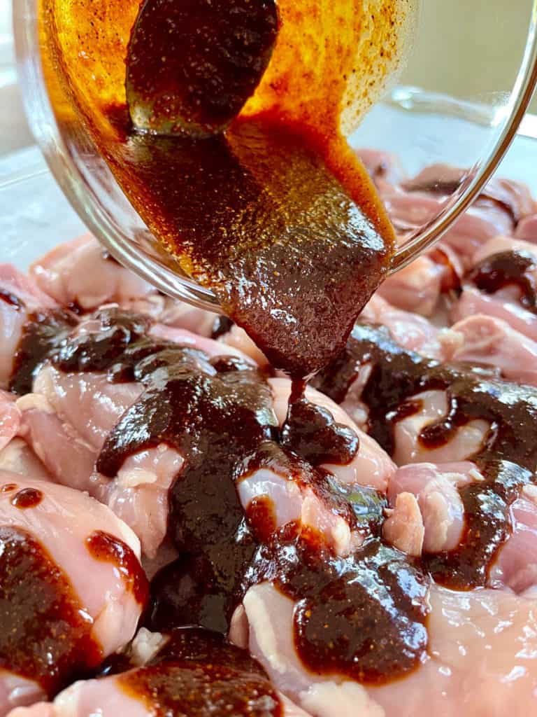 Marinade pouring over chicken.