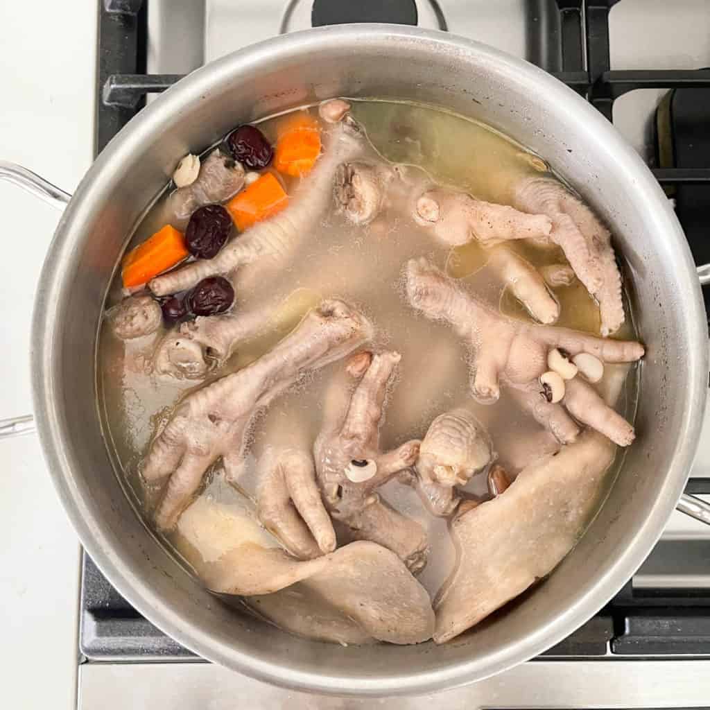 Lower the heat to simmer and cook chicken foot soup for 45 mins. 