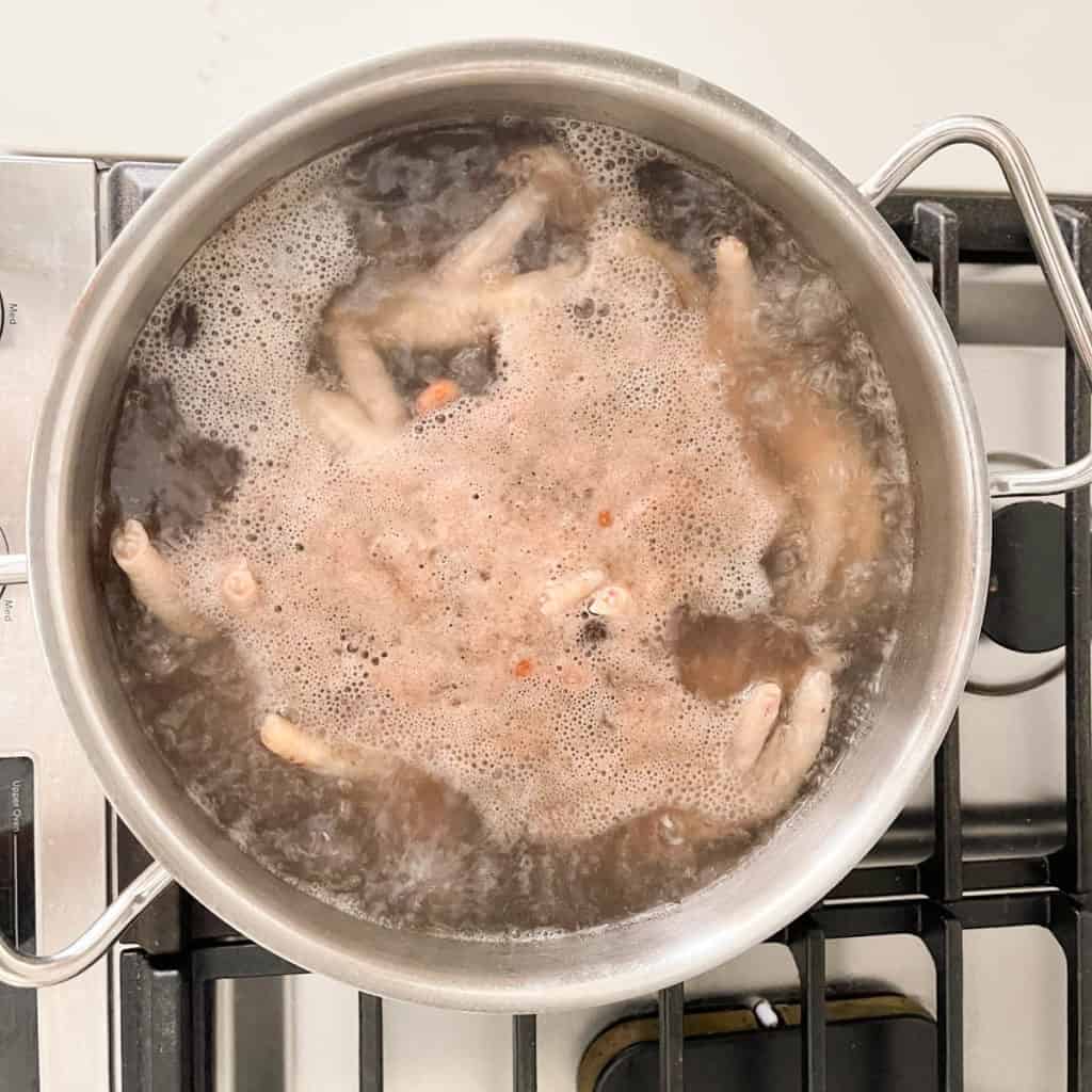 After rapid boiling for about 3 minutes, a layer will form on the surface.  Discard this foamy layer and water for clearer broth.