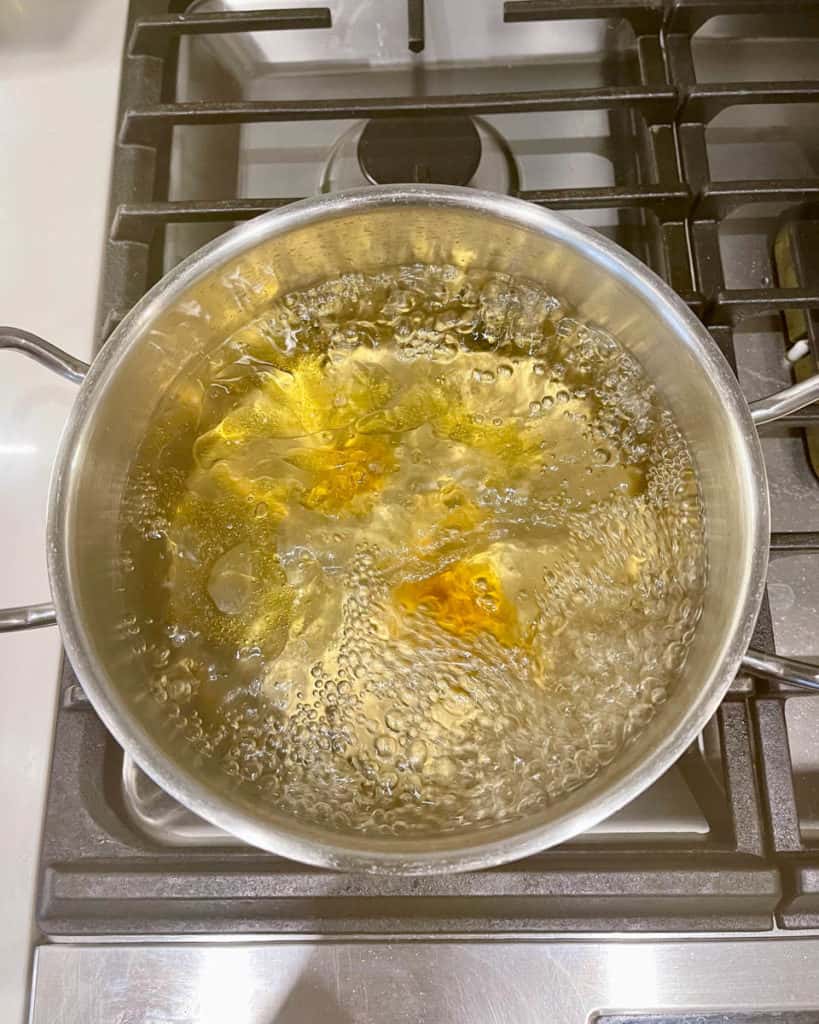 Water for blanching yu choy including oil, salt and sugar.