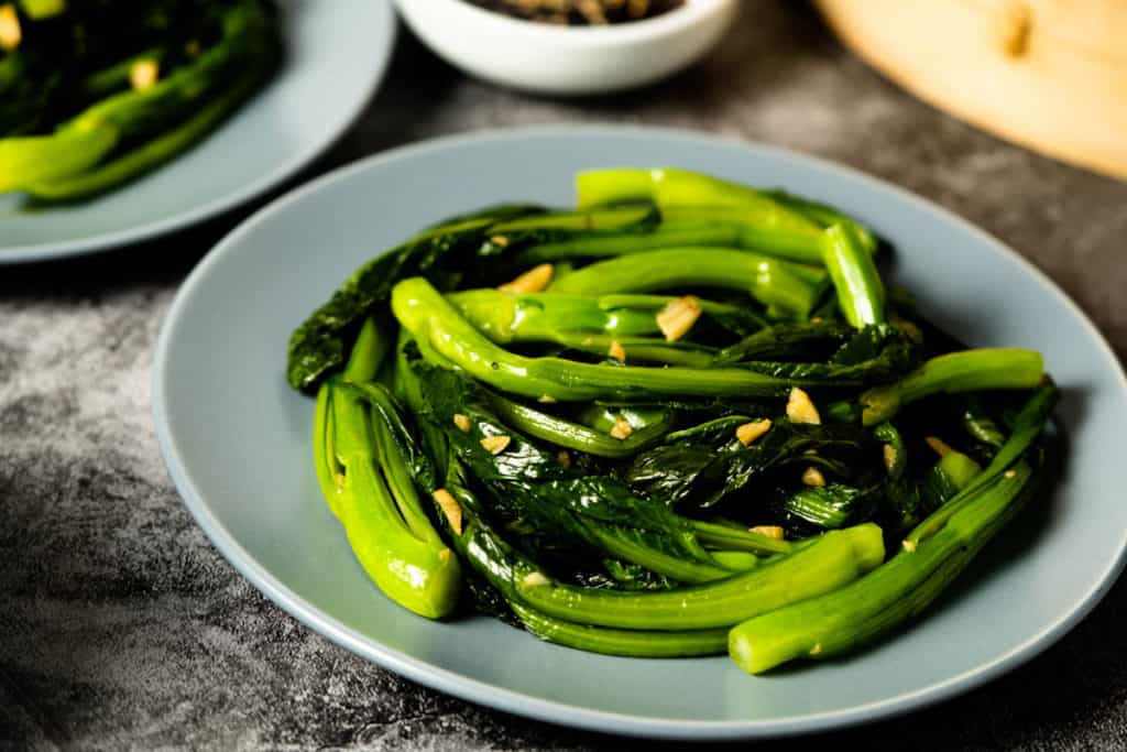 Plate of stir fried yu choy with garlic.
