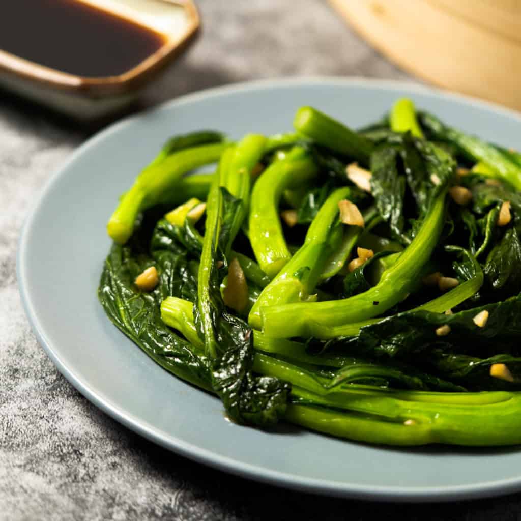 Yu choy close up with minced garlic.