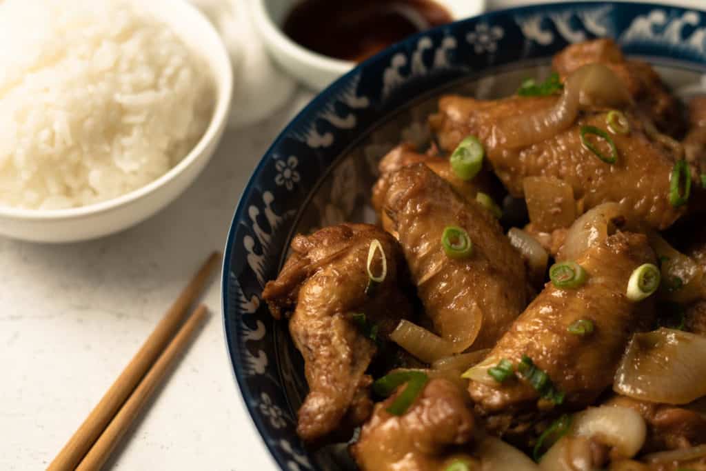 close up of the garlic soy chicken wings dish with rice on the side