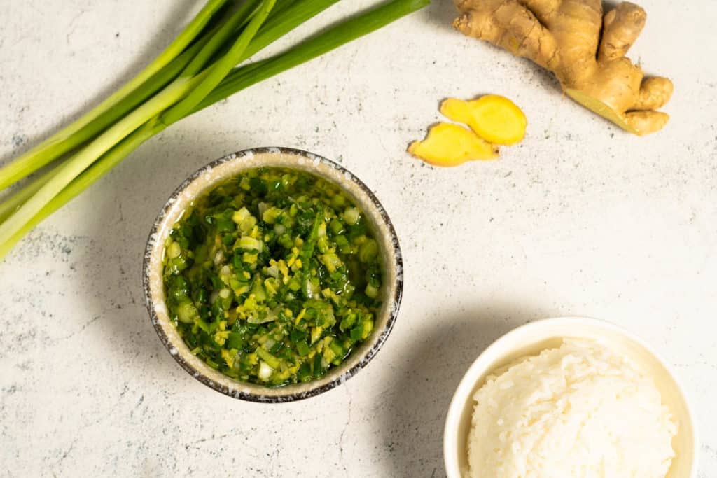 Top view of a bowl of ginger scallion sauce.