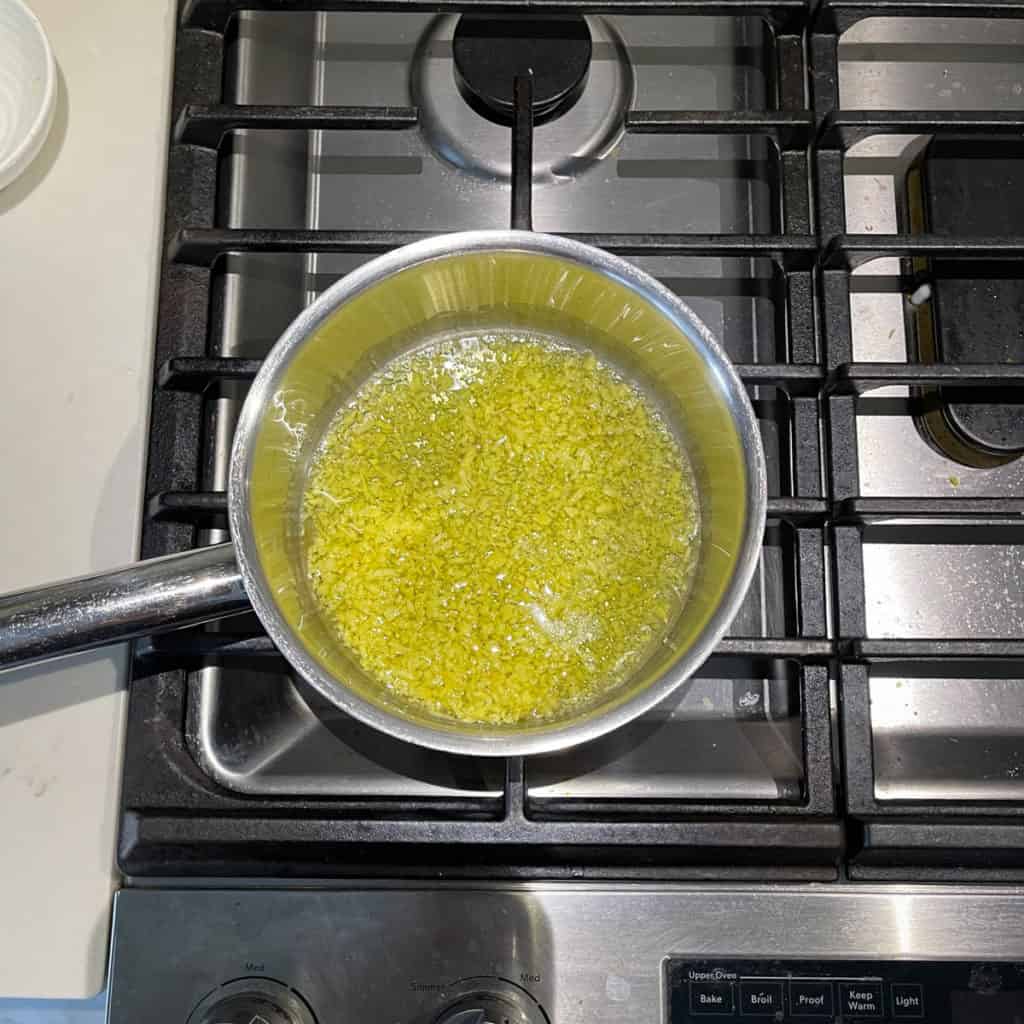 Minced ginger in a pot with oil.