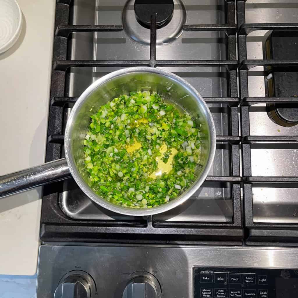 Slightly wilted green onions in a pot.