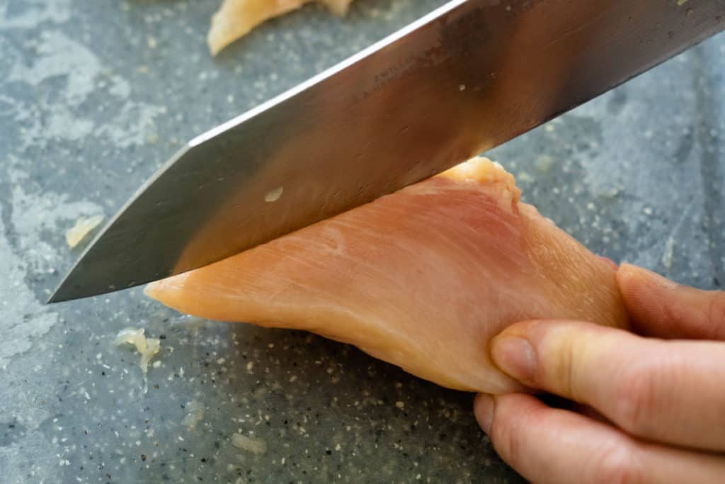 Slicing chicken against the grain.