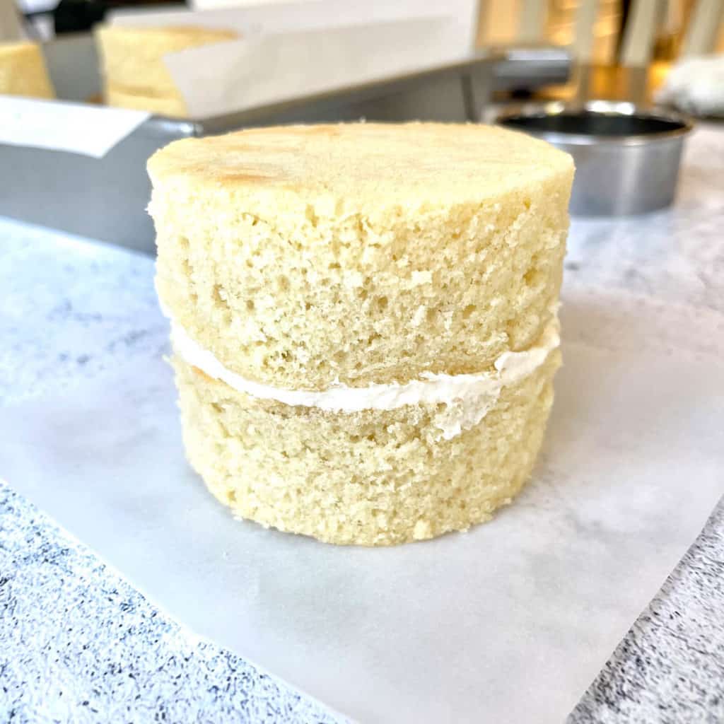 Two lunch box cake tiers stacked.
