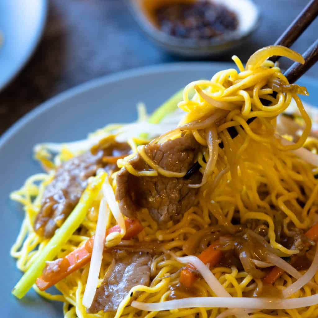 Pork chow mein close up with tender pork slices.