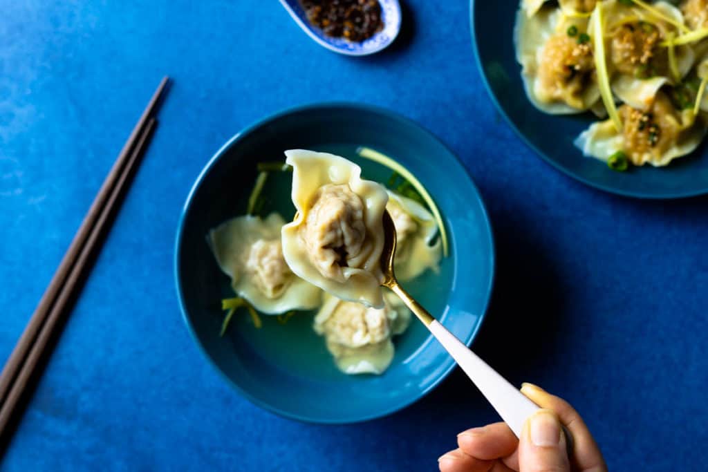 Single wonton close up in a spoon.