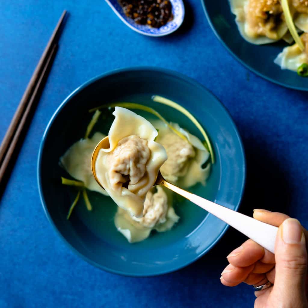 Single wonton close up in a spoon.