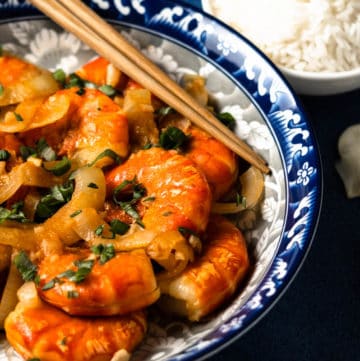 Stir fried shrimp in ketchup sauce on a plate.