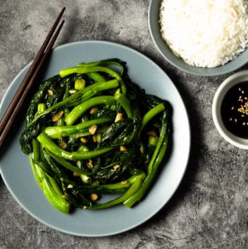 Yu choy sum on a plate with rice.