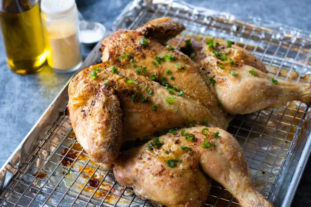 4 ingredient roast chicken on a baking tray.