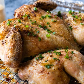 Whole roasted chicken on a wire rack.
