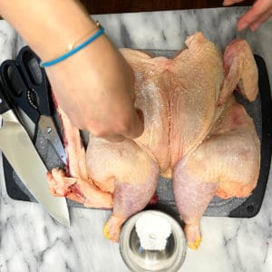 Sprinkling salt all over the chicken.