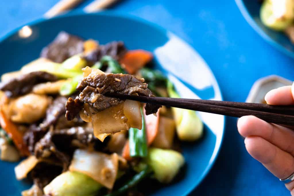 Closeup of beef slices and rice noodles.