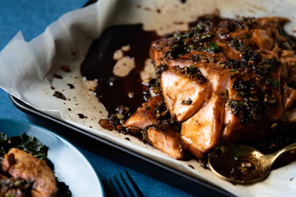 Soy maple glazed salmon baked moist and tender in a baking pan.