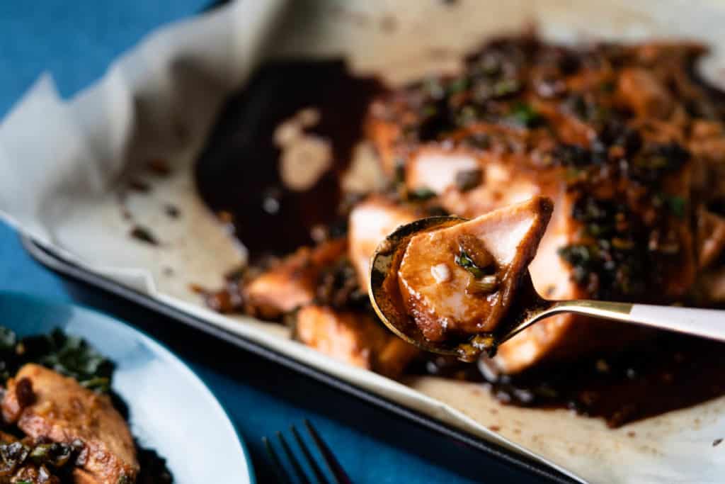 A moist flaky piece of salmon on a spoon.