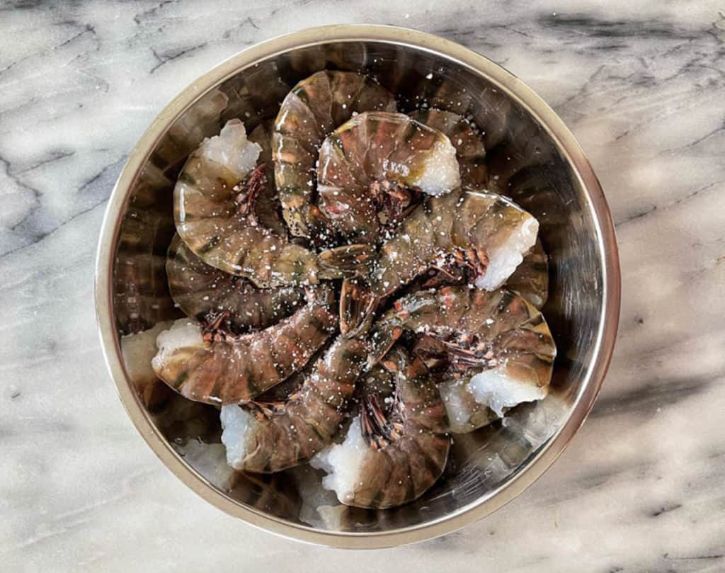 Bowl of raw shelled jumbo shrimp.
