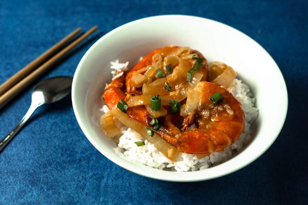 Stir fried jumbo shrimp on a bed of rice.