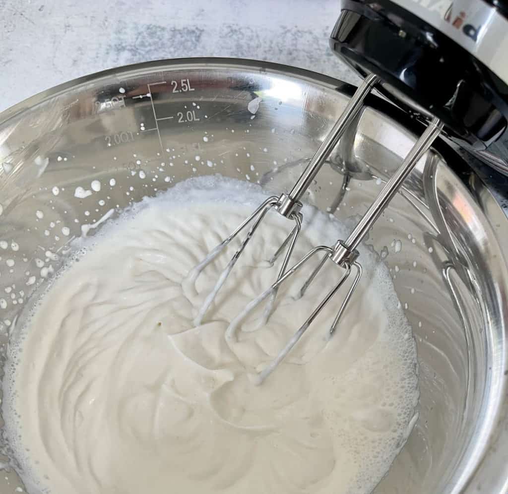 Beat whipped cream on high speed till soft peaks form.
