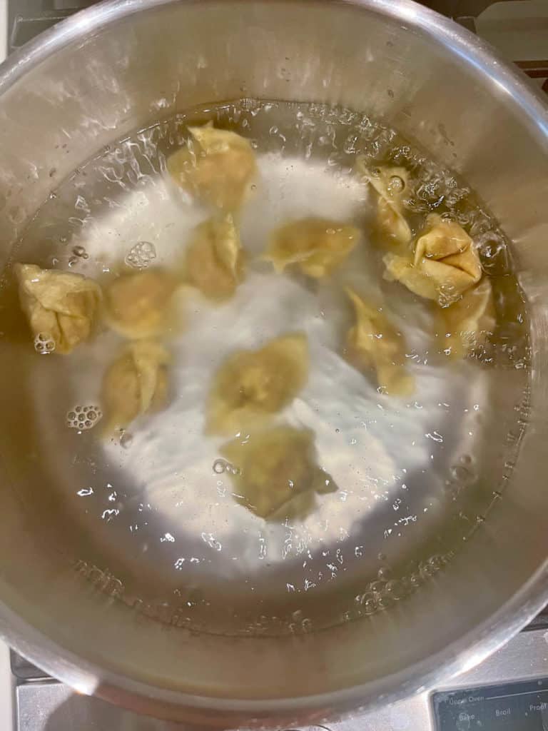 Raw wontons will sink to the bottom of the pot.