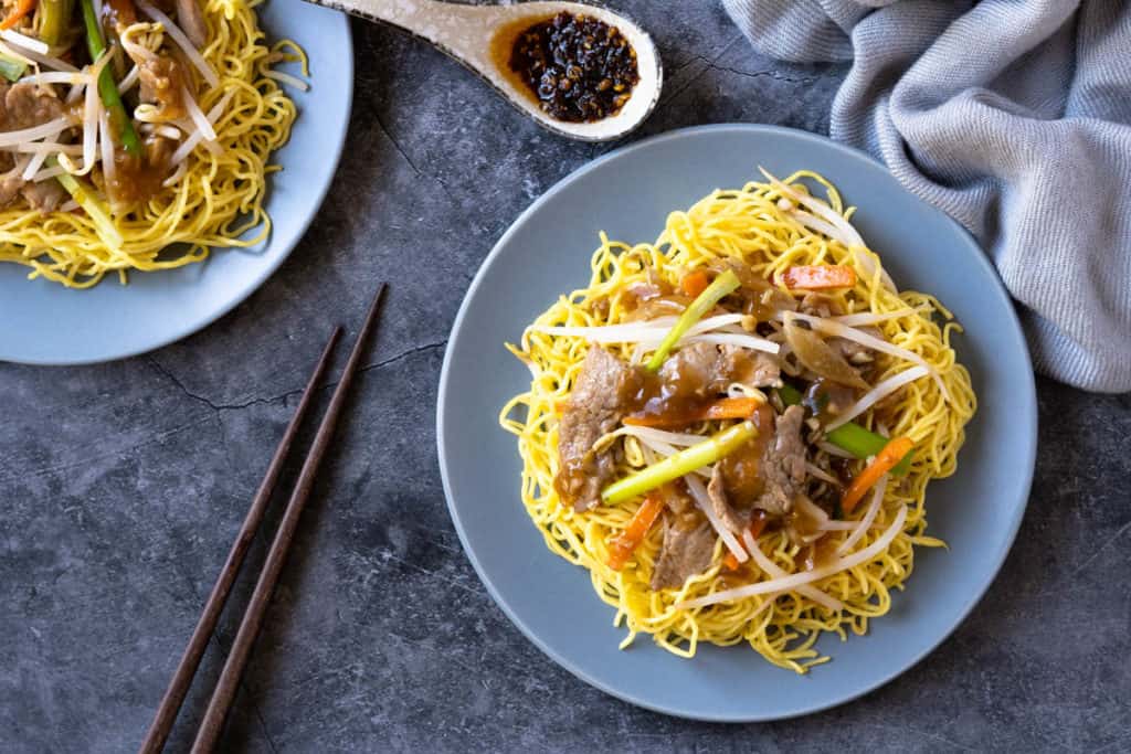 Pork chow mein on a plate ready to eat.