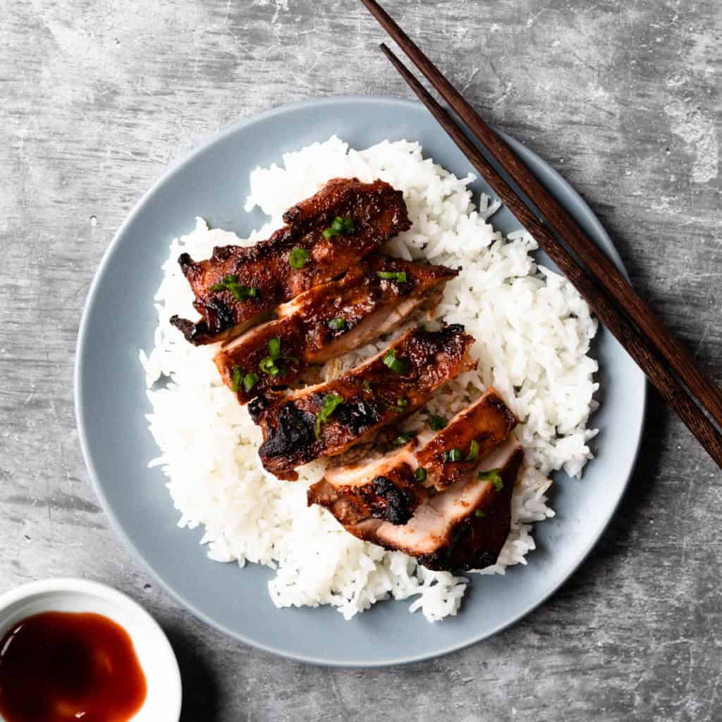 Sliced char siu chicken on a bed of steamed rice.