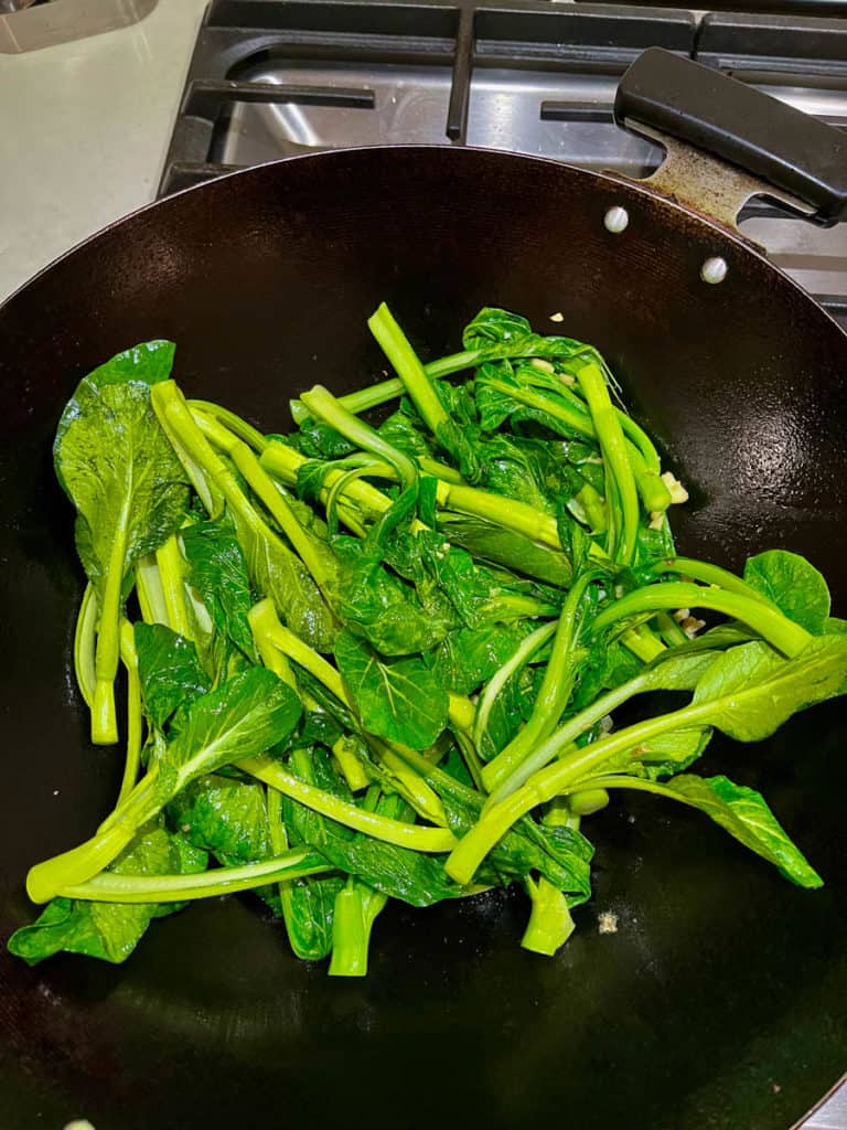 Stir frying vegetables in hot oil in wok.