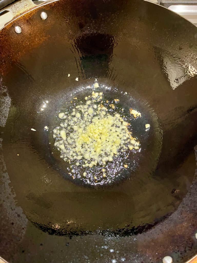 Stir fry minced garlic in hot oil.