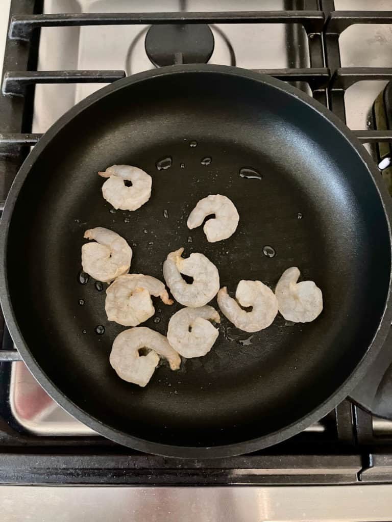 Shrimps frying in a pan.