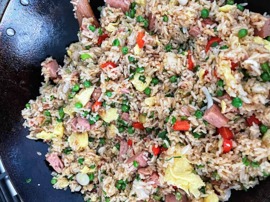 Spam fried rice in a wok.