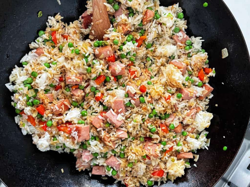 Spam fried rice stirring with soy sauce.