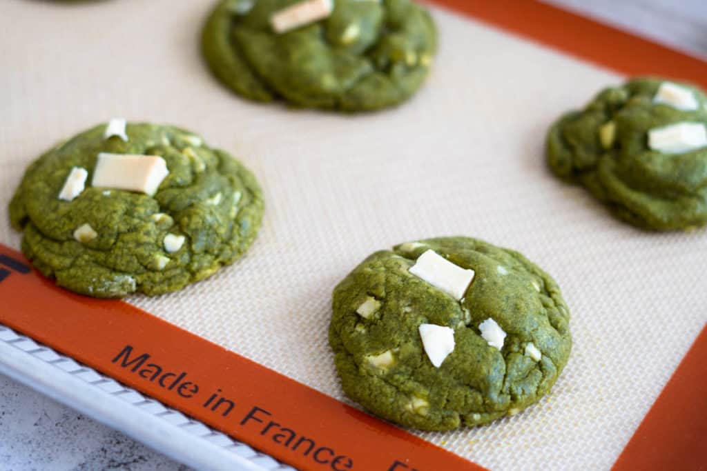 Matcha cookies just baked on a tray.