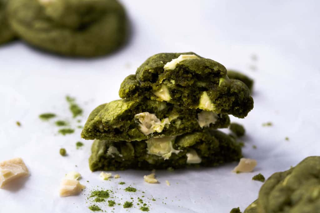 Matcha cookies stacked to show soft and chewy insides.