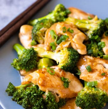 Broccoli and slices of chicken stir fry on a plate.