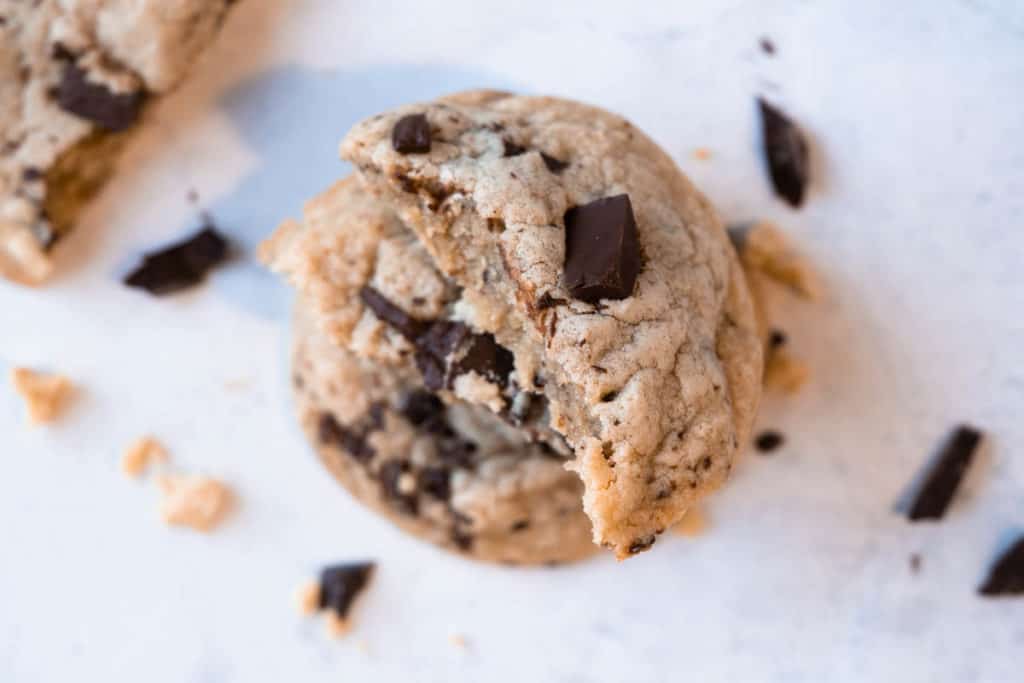 Close up of a chocolate chip cookie broken in half.