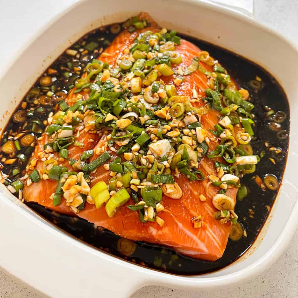 Uncooked salmon fillet with maple soy marinade.